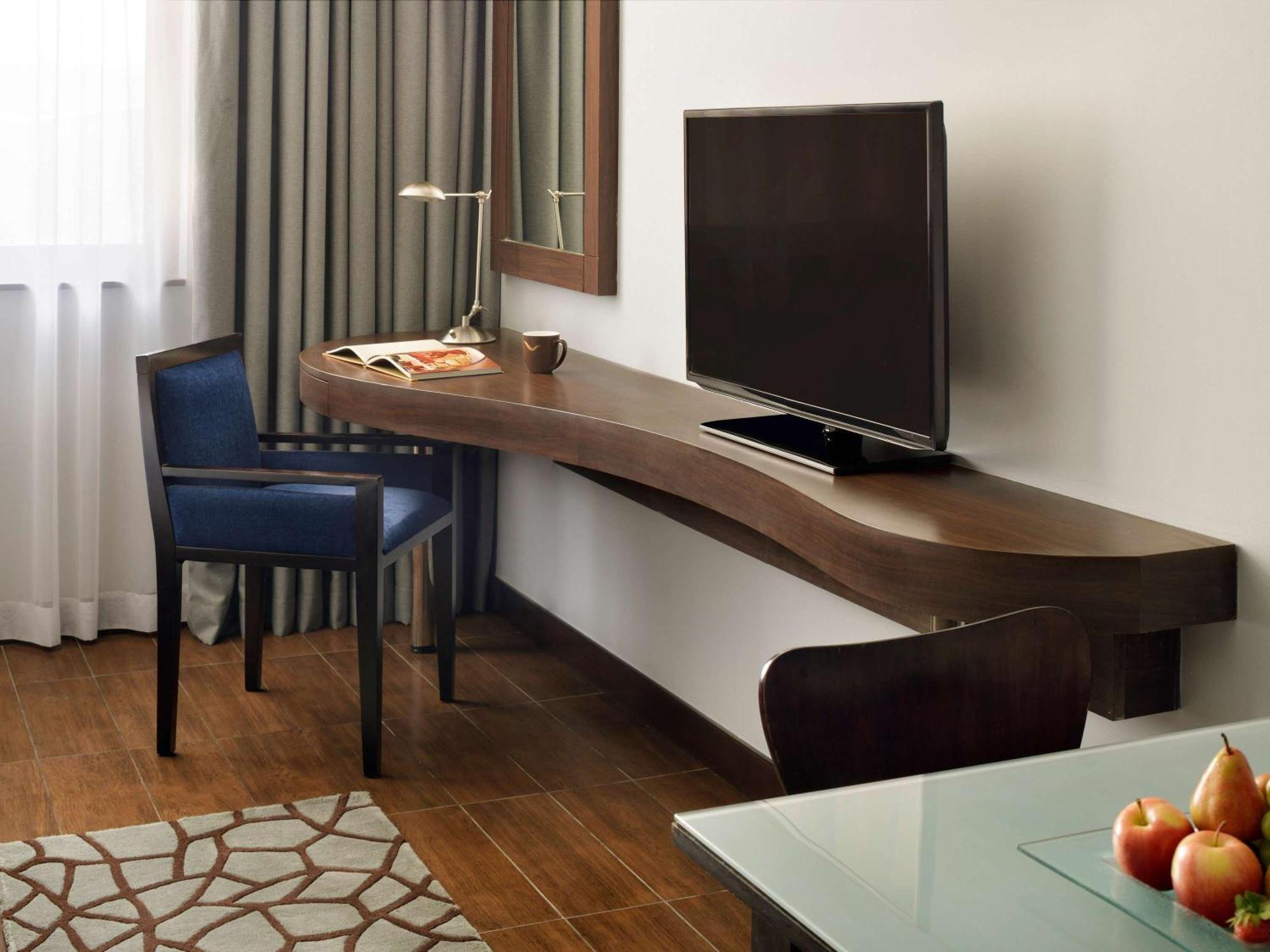 Moevenpick Hotel Apartments Al Mamzar Dubai Esterno foto A television in a hotel room